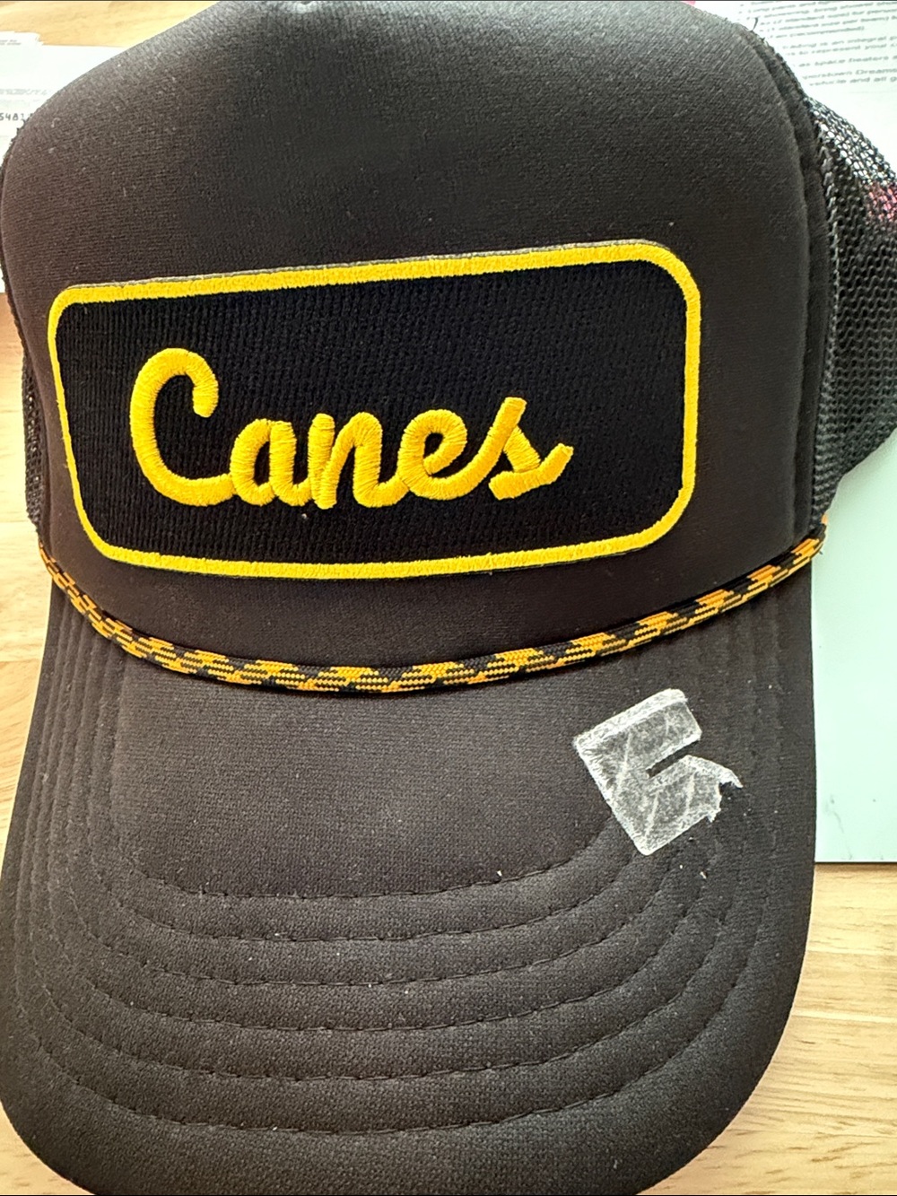 Black Mesh Trucker Cap with Embroidered Canes Logo in Yellow